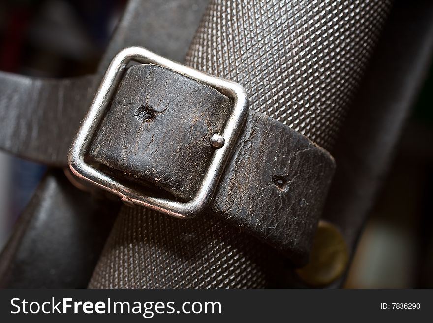 Black leather belt around a metal shaft to a knife