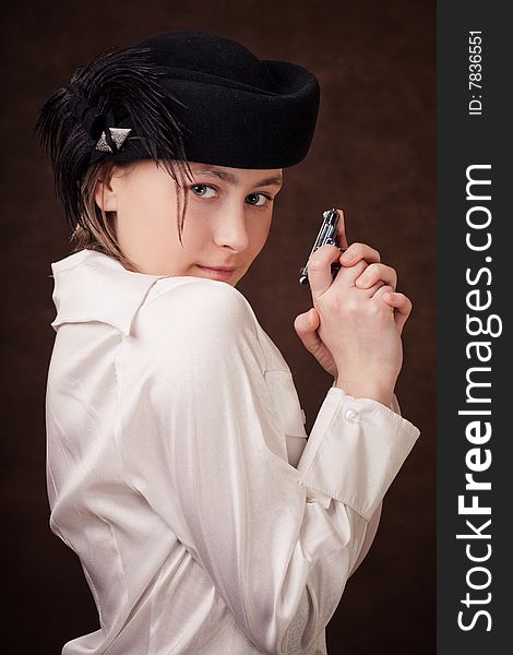 Young girl is holding a toy pistol in hands. Young girl is holding a toy pistol in hands