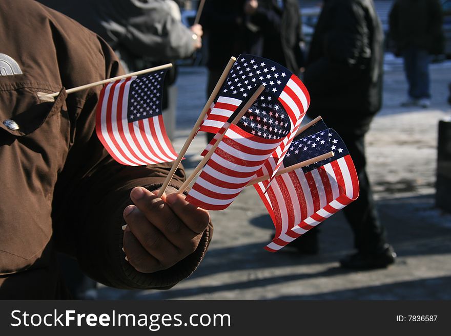 Man with a handful of U.S. flags.