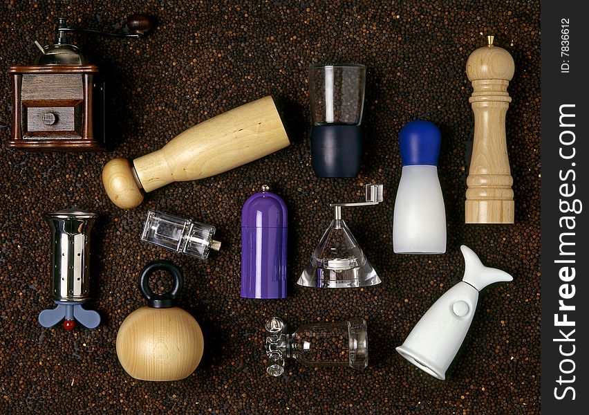 Various pepper mills on background from pepper