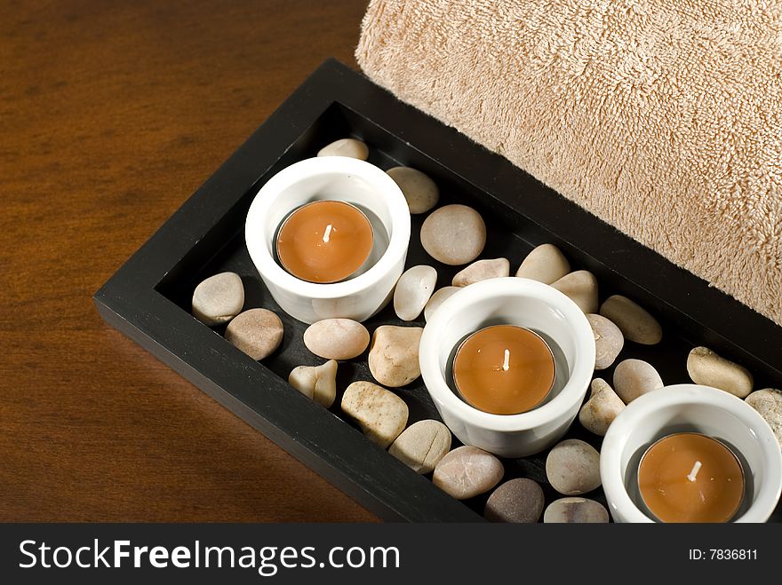 3 tea lights with brown towel. 3 tea lights with brown towel