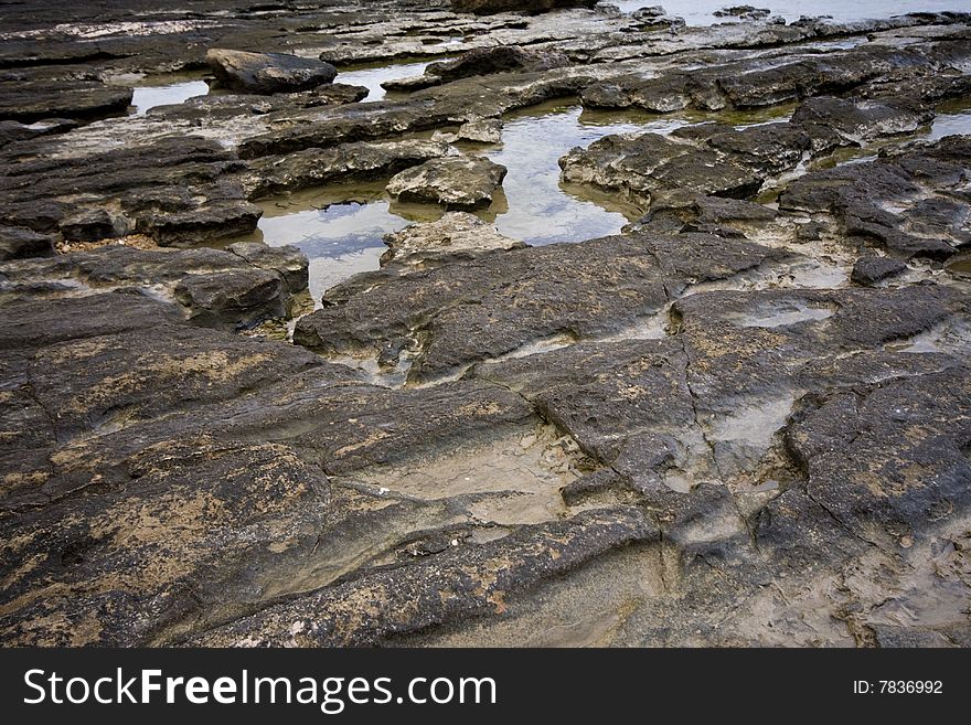 Pools among the rocks by the sea on a winter day. Pools among the rocks by the sea on a winter day