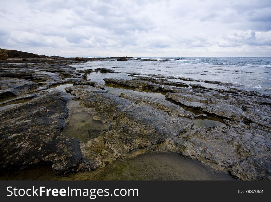 Pools among the rocks by the sea on a winter day. Pools among the rocks by the sea on a winter day