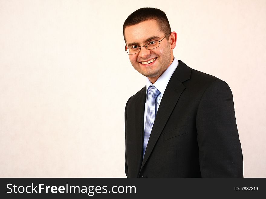 Young businessman on isolated background smiling