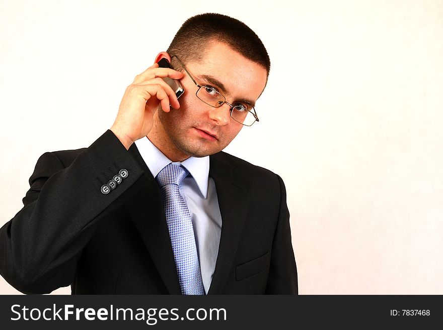 Young businessman on isolated background with a cell phone. Young businessman on isolated background with a cell phone