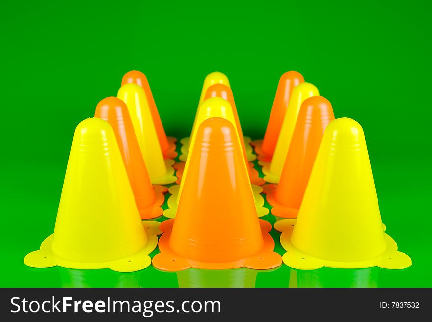 Witches hats isolated against a green background