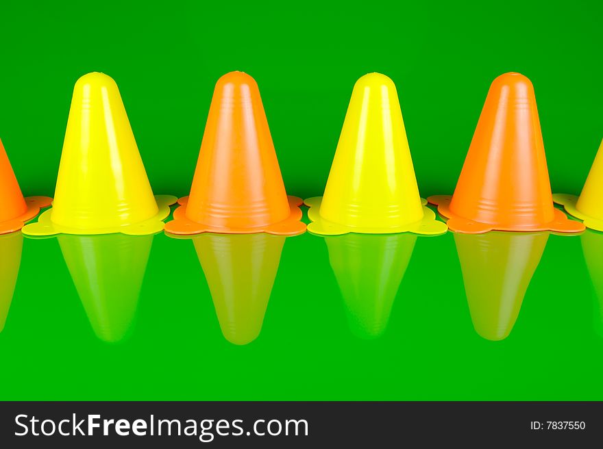 Witches hats isolated against a green background