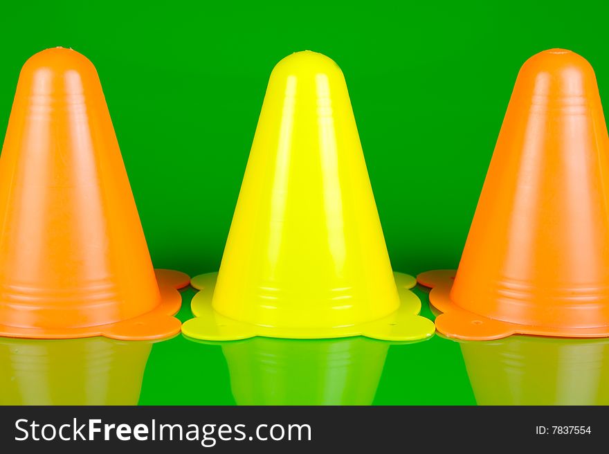 Witches hats isolated against a green background