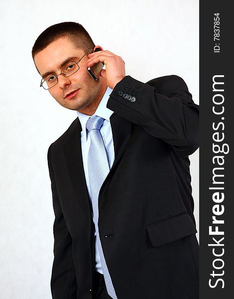 Young businessman on isolated background with a cell phone. Young businessman on isolated background with a cell phone