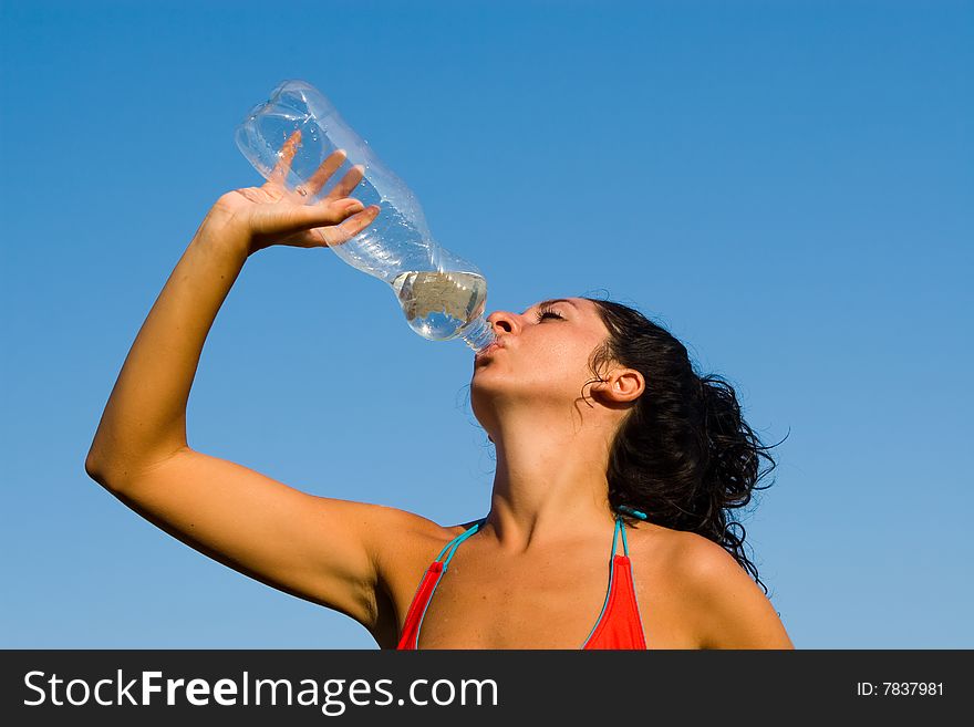 Girl Drinking Water Against Sky