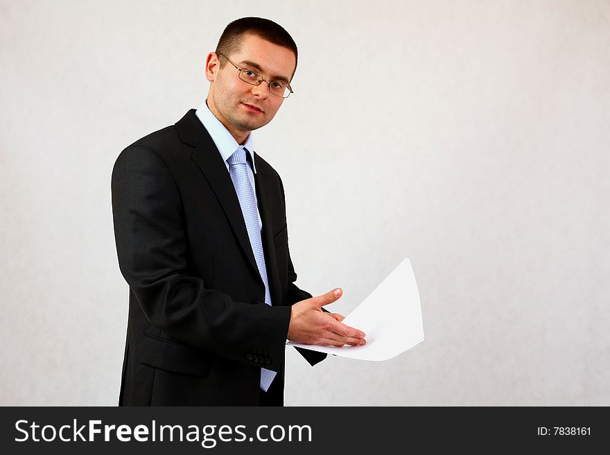 Young businessman on isolated background with a piece of paper. Young businessman on isolated background with a piece of paper