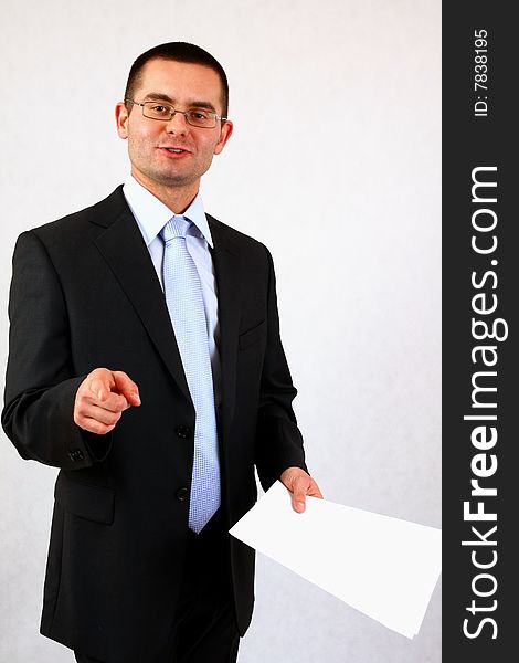 Young businessman on isolated background pointing with his finger. Young businessman on isolated background pointing with his finger