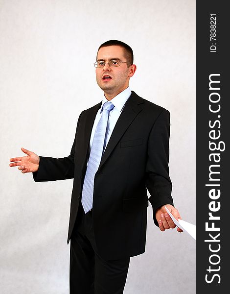 Young businessman on isolated background with a piece of paper. Young businessman on isolated background with a piece of paper