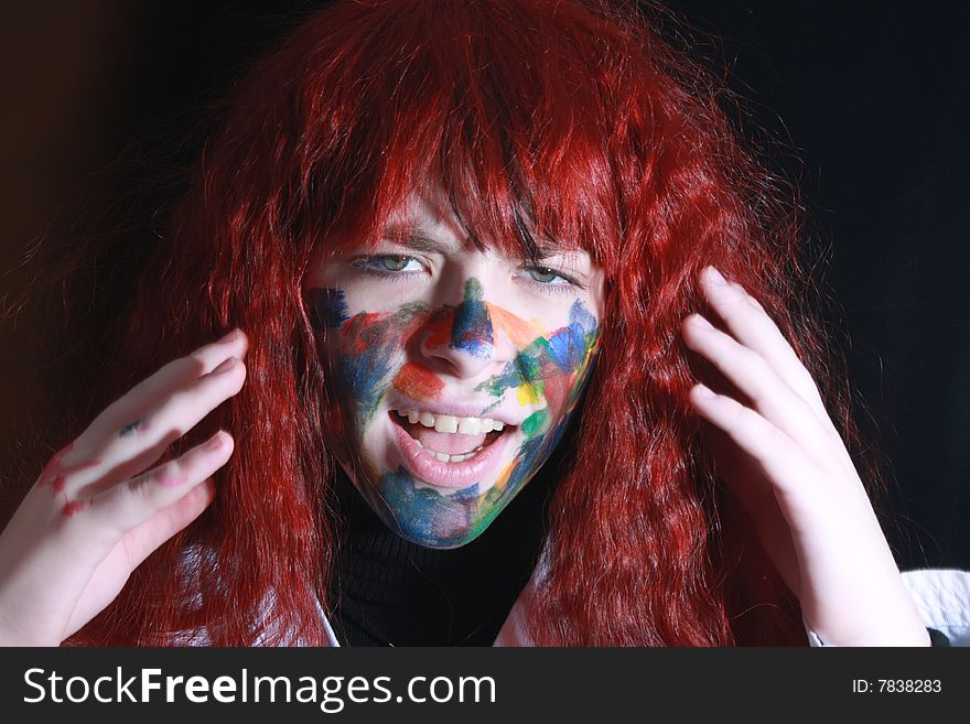 Young crazy girl with colored face