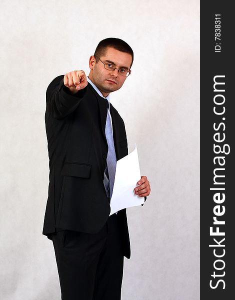 Young businessman on isolated background pointing with his finger