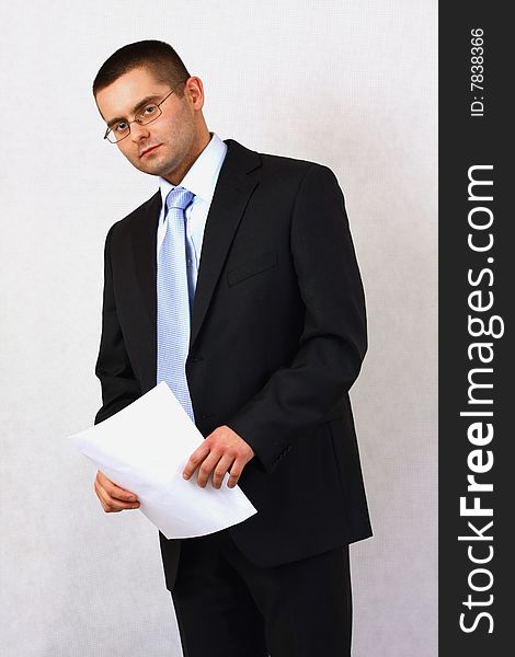 Young businessman on isolated background with a piece of paper. Young businessman on isolated background with a piece of paper