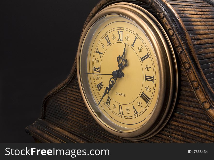 Old Wooden Clock on Black Background