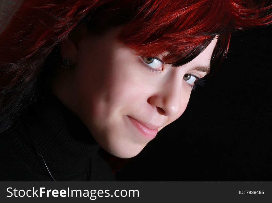 Red beautiful girl portrait on black background. Red beautiful girl portrait on black background