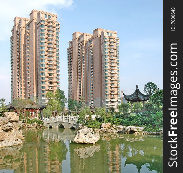 There are two upscale apartment block by the lakeside,beautiful reflection in the calm lake water suface.