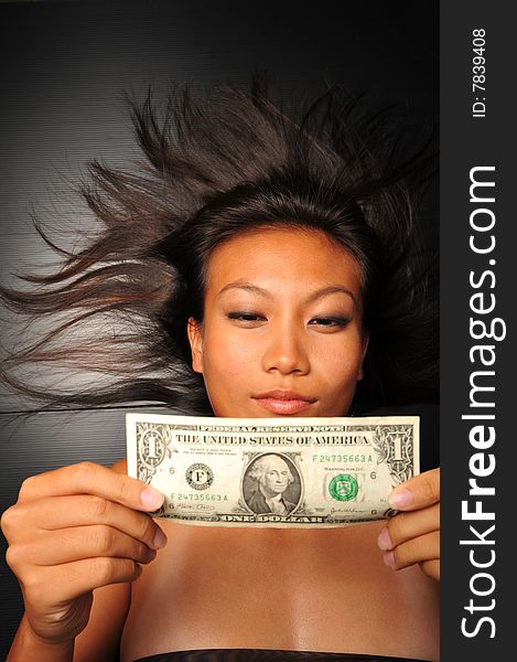 Chinese Asian Woman Looking At Dollar Bill