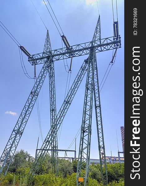 High voltage electrical overhead line on blue sky