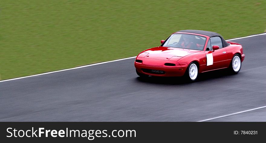 A Sports Car going down the straight.