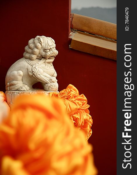 Stone lion by the red wall of Badachu Temple ,Beijing ,China