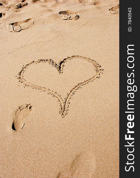 A heart sign in the sand on a beach. A heart sign in the sand on a beach