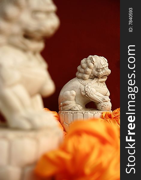 Stone lion by the red wall of Badachu Temple ,Beijing ,China