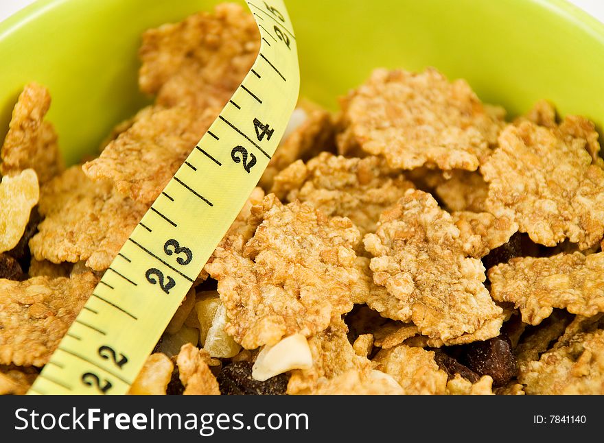 Close-up image of cereal flakes and yellow tape measure. Close-up image of cereal flakes and yellow tape measure