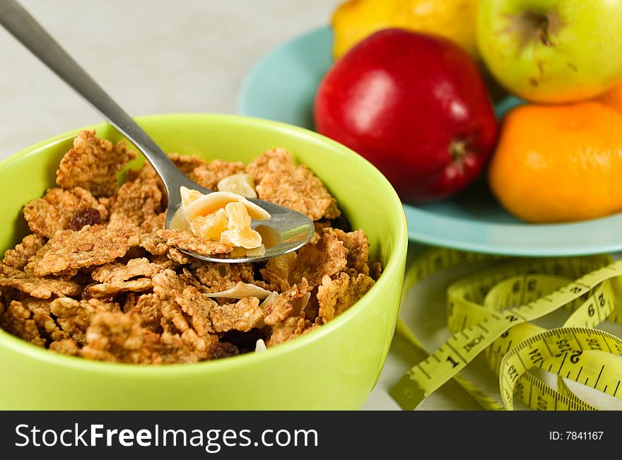 Cereal flakes and dried fruits in a green bowl. Cereal flakes and dried fruits in a green bowl