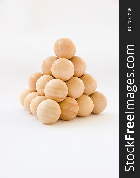 Ooden balls arranged in Pyramid shape shows a growth. Ooden balls arranged in Pyramid shape shows a growth