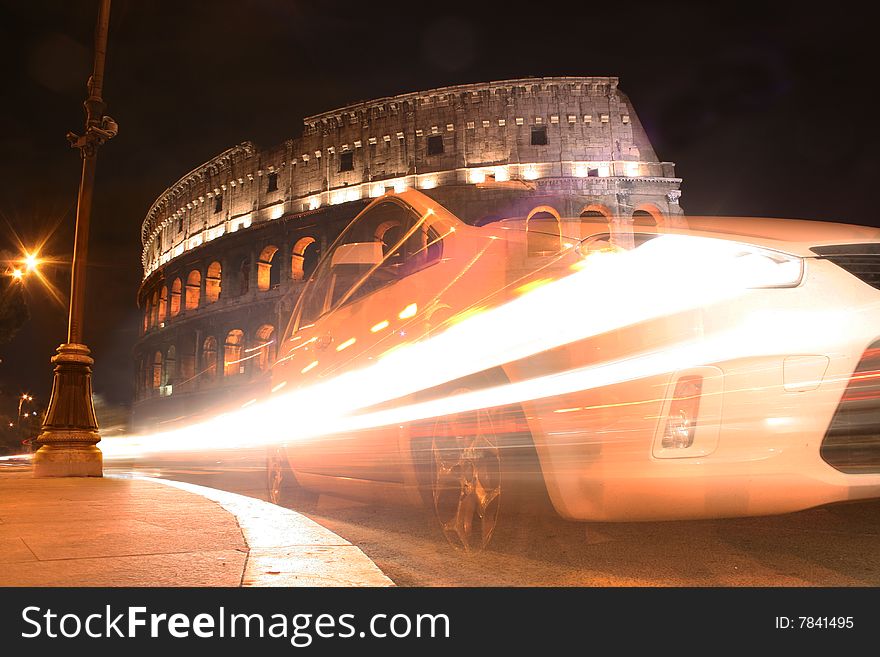 Colosseum by night with car