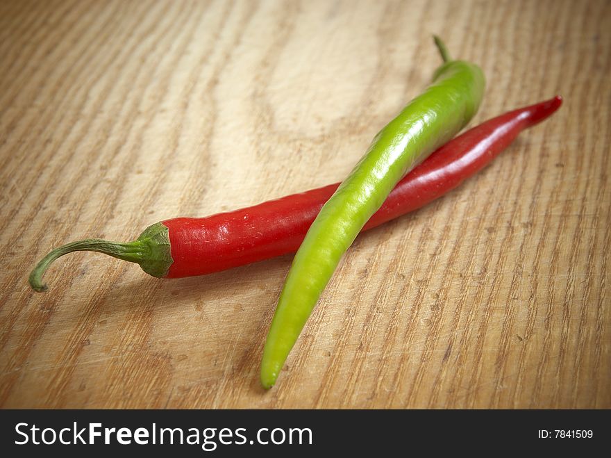 Red and green chili on wooden background. Red and green chili on wooden background