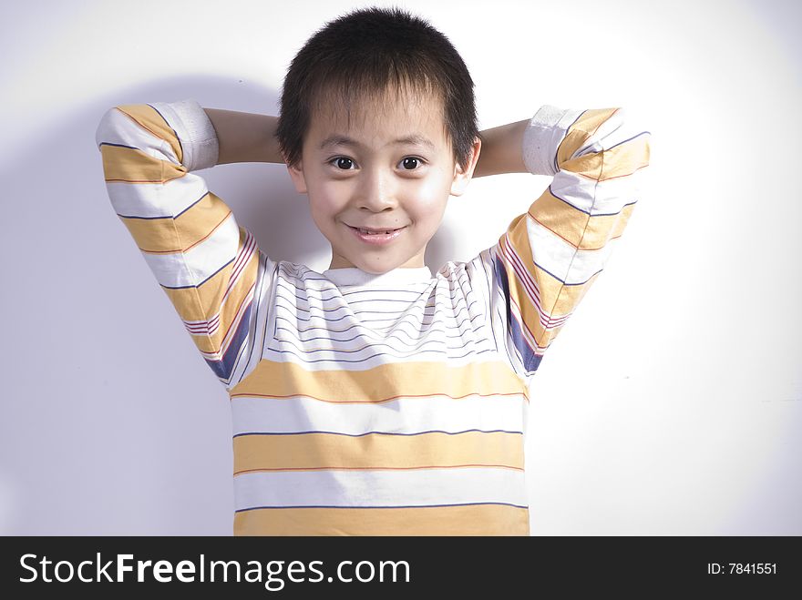 A Boy puts this hands back of head