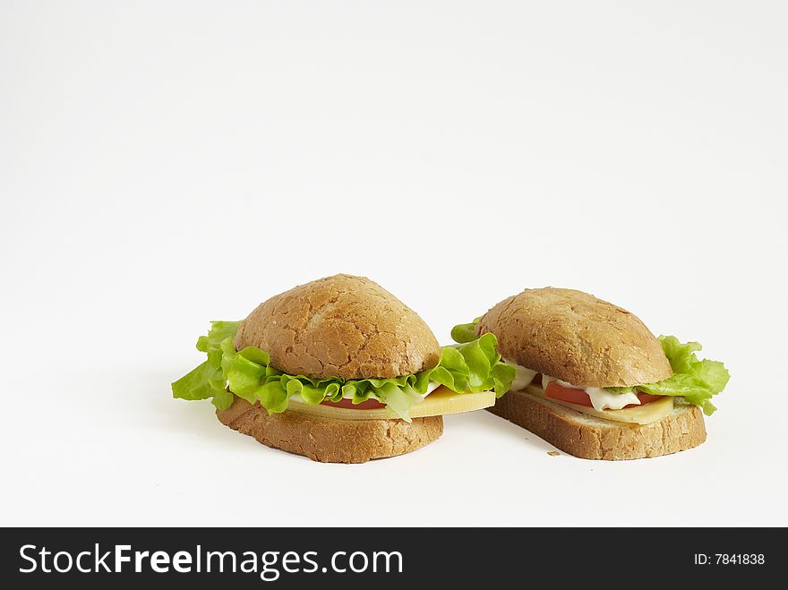 Two sandwiches with tomato, cheese and salad