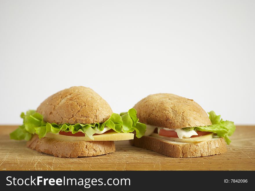 Two sandwiches with tomato, cheese and salad