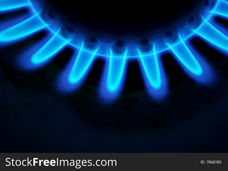 Blue flames of gas stove in the dark