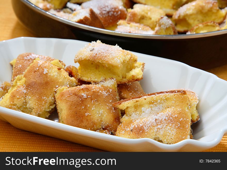 Baked dough with powdered sugar on plate