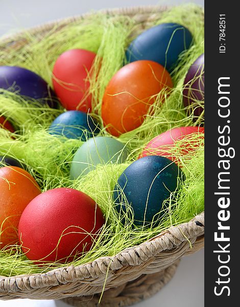 Easter eggs in basket on table