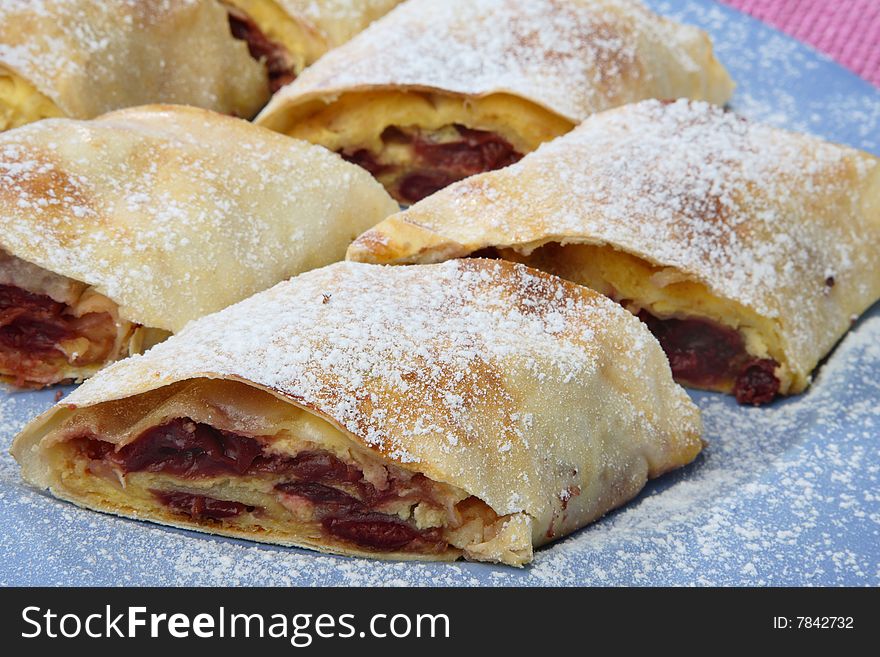 Sour cherry pie with sugar on plate