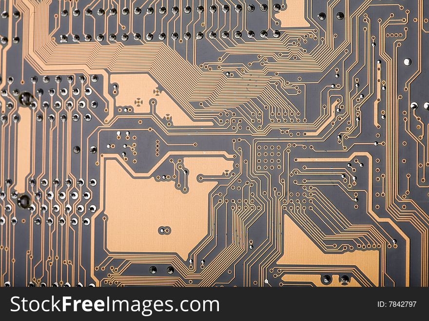 Close-up of a section of the back of a computer motherboard circuit board. Close-up of a section of the back of a computer motherboard circuit board