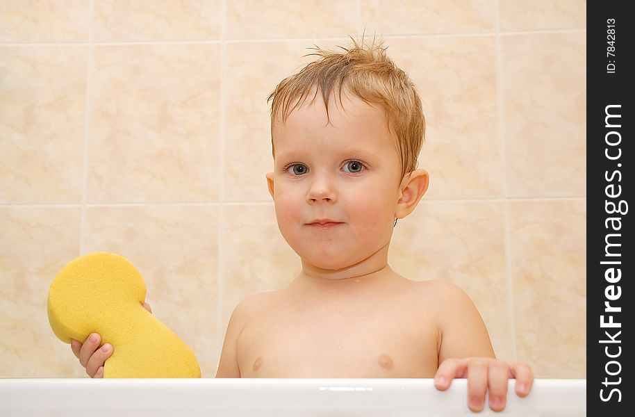 Little boy in a bath with a bast in a hand. Little boy in a bath with a bast in a hand