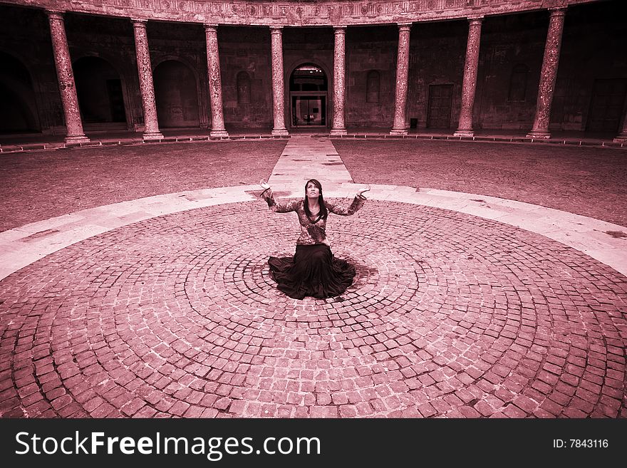 Young woman prayer inside ancient building