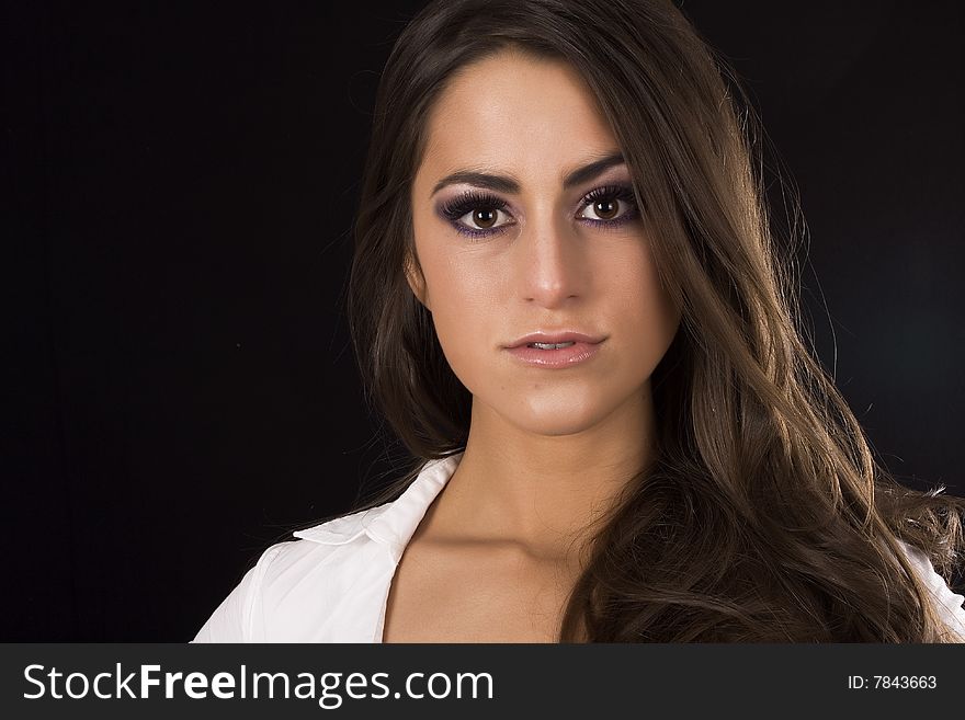 Beautifull brunette model posing on a black background. Beautifull brunette model posing on a black background
