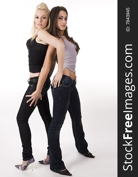 Blond and brunette model posing in jeans. Blond and brunette model posing in jeans