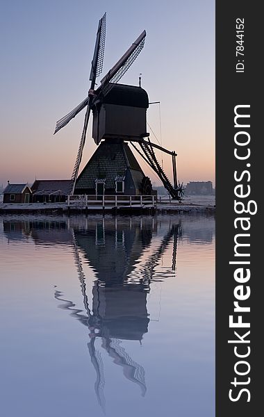 Dutch windmill with reflection in the water