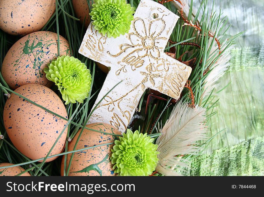 Decorated eggs in a wreath on a green background. Decorated eggs in a wreath on a green background