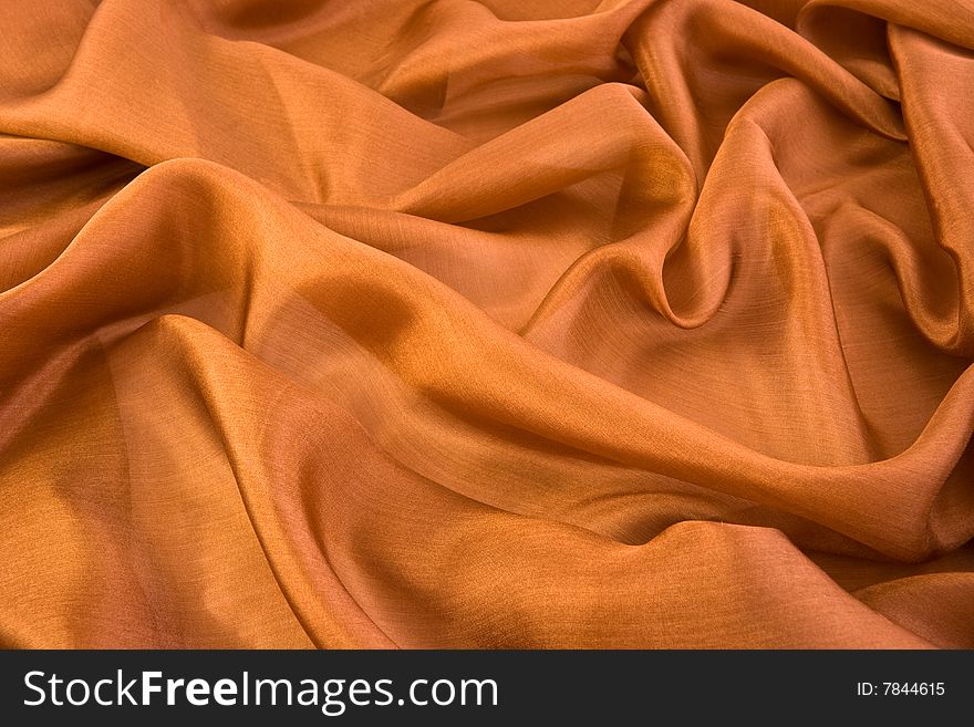 Folds on brown aglint silk
