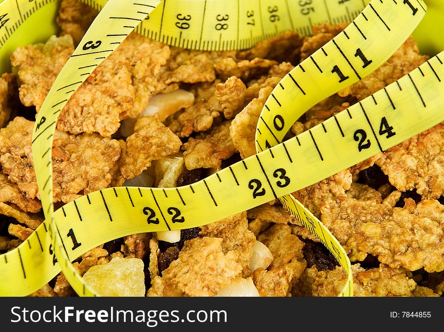 Close-up image of cereal flakes and yellow tape measure. Close-up image of cereal flakes and yellow tape measure